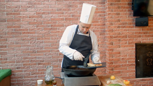 Chef putting fried dumplings with seafood on plate