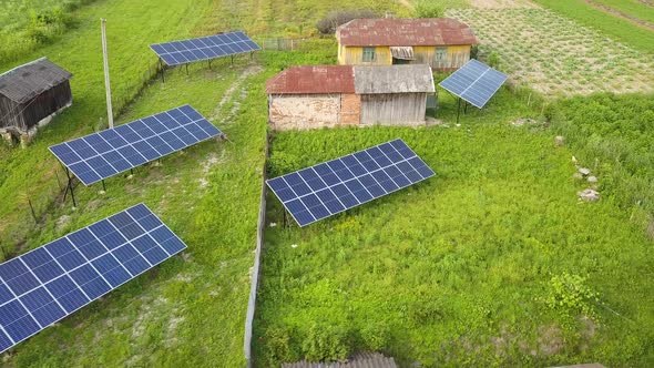 Aerial top down view of solar panels in green rural area. alt
