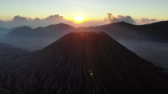 Aerial view of sunrise over mountains and clouds