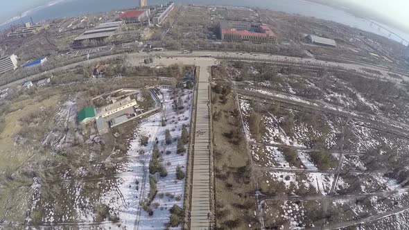 Flying over riverside city in spring alt