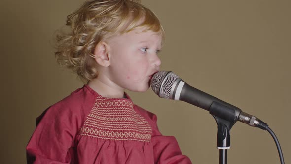 Cute Little Girl Sing Song Into Microphone, Funny Toddler Enjoing Broadcasting