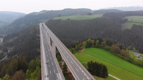 Aerial View of the Highway Viaduct on Concrete Pillars in the Mountains alt