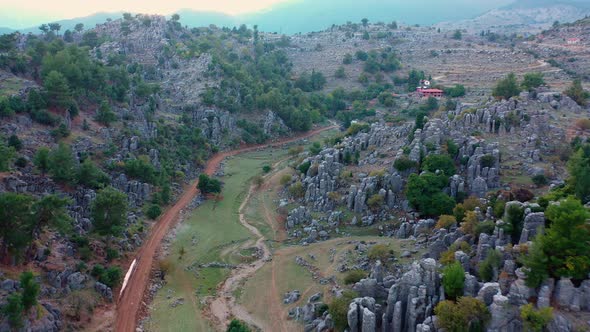 Mountains Landscape Scenery with Gray Rock Formations and Evergreen Forest alt