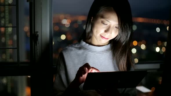 Woman use of mobile phone at night alt