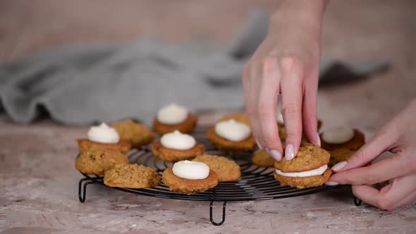 Woman Makes a Carrot Cookies with Cream Cheese Filling