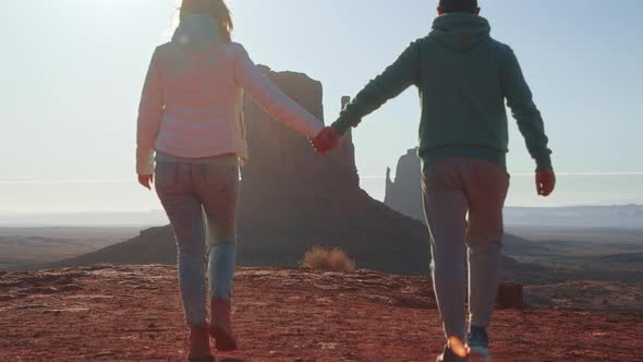 Romantic Couple Walking Together Holding Hands Sunny Morning in Monument Valley alt