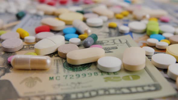 Color Capsules and Pills on Dollar Bills Pharmacy Business Concept Slider Shot alt