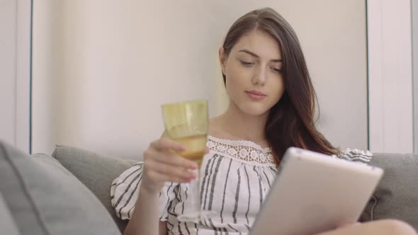 Woman reading digital book at home