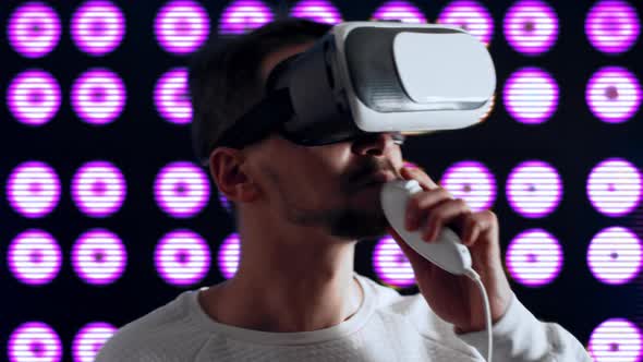 Man with Virtual Reality Glasses Makes Toast and Drinks Alcoholic Beverage