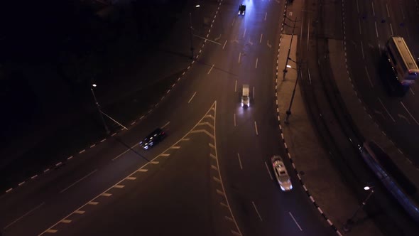 City streets aerial look down, cars on night road