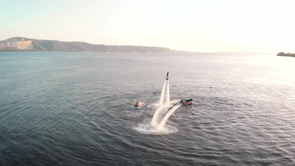 Courageous People Riding Jet Pack Over Water alt