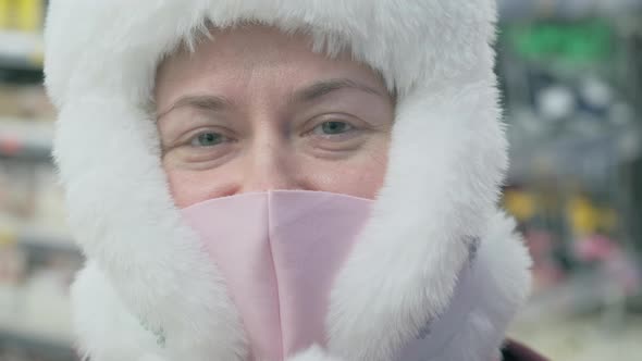 Girl in a Pink Mask Against the Virus and a Big White Hat