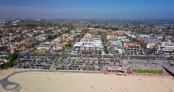 Huntington Beach symbol of Surf City, USA bird's eye view. Pacific highway with cars and beach