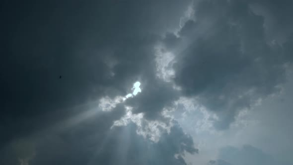 The Sky with Rain Clouds Through Which the Sun's Rays Break Through