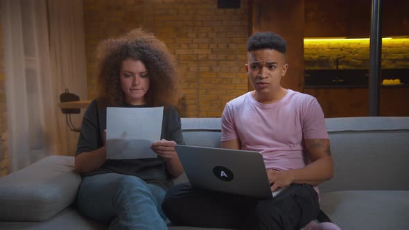 Millennial African American Male Student Has Online Exam or Lesson and Woman Helping Him with Right alt