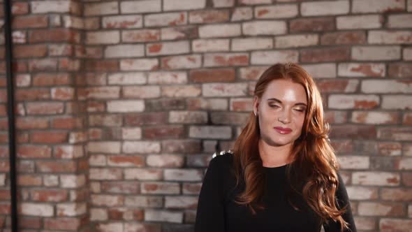 Cheerful Redhead Girl Is Walking Over Big Room and Flirting with Camera alt