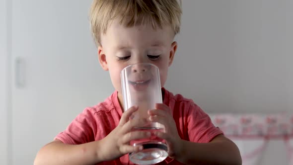 Portrait of Boy Drinking Glass of Water alt