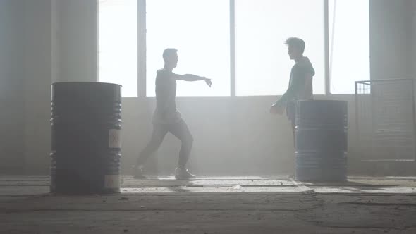 Urban Dance Battle of Two Street Dancers in an Abandoned Building Near the Barrel alt