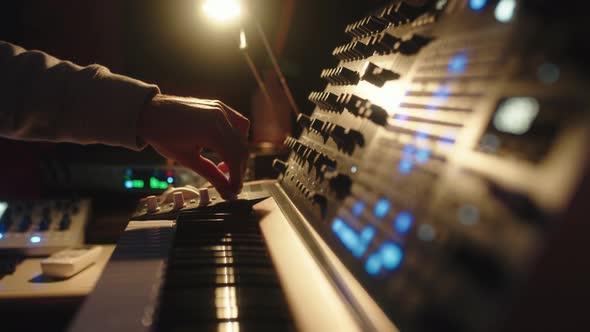 Hands of a Man Sound Engineer are Pressing Buttons on the Console alt