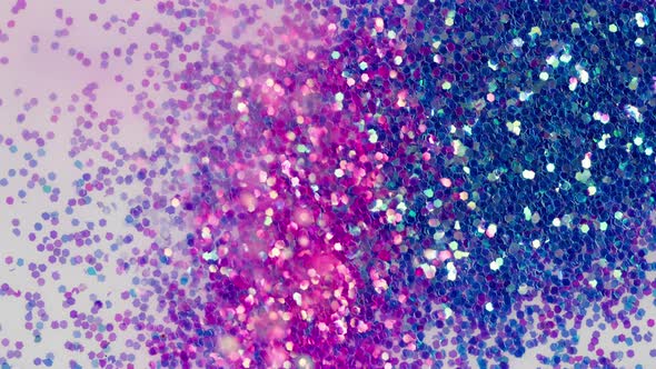 Pouring Pink Glitter on White Background Gloss Powder Closeup alt