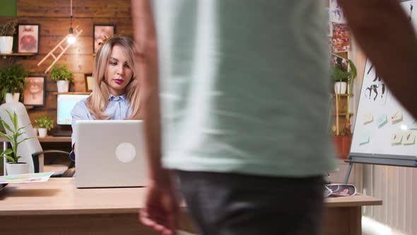 Beautiful Blonde Woman Working on Her Computer in a Professional Creative Workplace alt