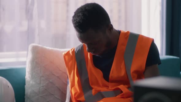 Tired African American Contractor Walking to Work alt