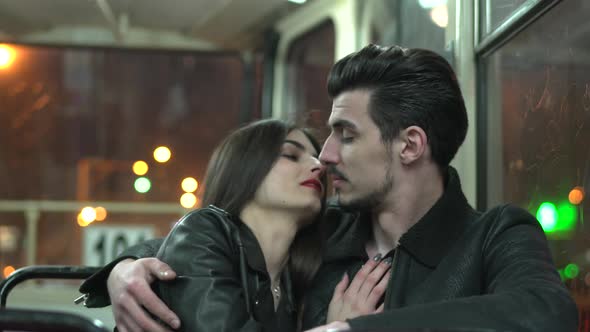 Couple kissing in a tram alt
