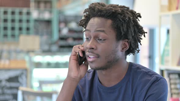 Portrait of African Man Talking on Smartphone alt