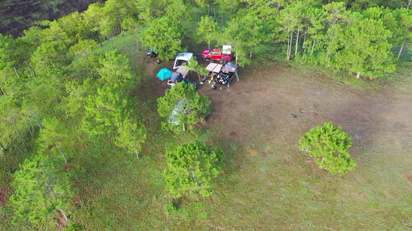 Aerial view of group Asian friends camp enjoying, relaxing nature on the hills