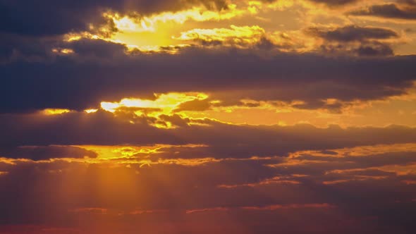 Sunset in the Sky Through Yellow Layered Clouds Timelapse alt