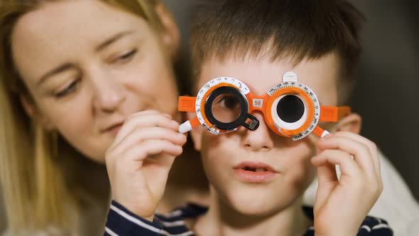 Close View: Cheerful Boy Plays with Vision Analyzing Device alt