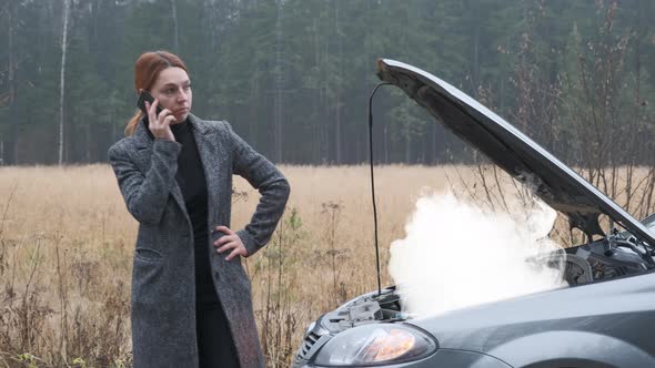 Woman on Countryside Road Trying To Get Help with Her Broken Down Car and Call alt