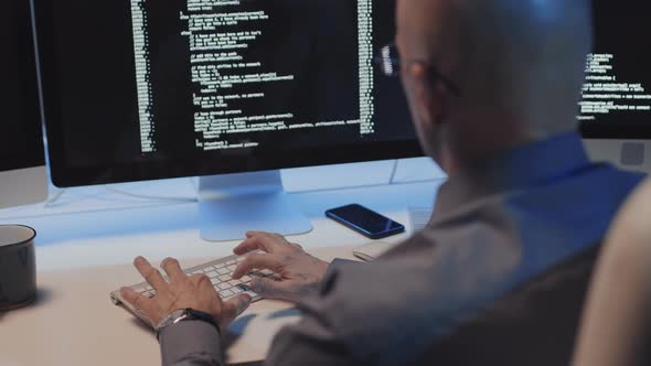 Mature Man Coding at Desk alt
