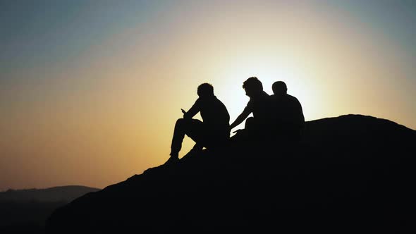 Silhouette Group of People Admiring the Sunset on Top of Mountain