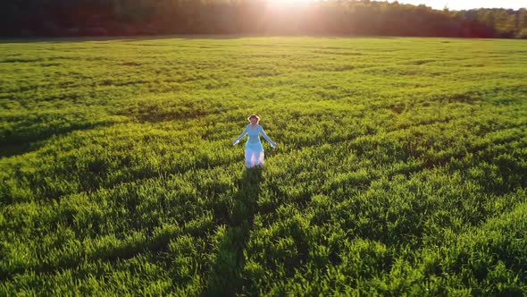 Girl Walking On Sunlight Field