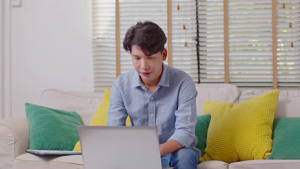 Stressed Asian businessman have a problem of him work so headache and migrain alt