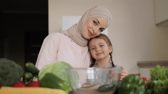 Muslim Mother and Child Daughter are Preparing Proper Meal with Vegetables alt