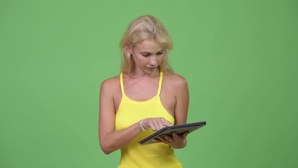 Young Happy Beautiful Blonde Woman Using Digital Tablet
