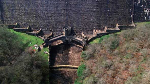 Pull out aerial over Plateley bridge at the base of Scar House Reservoir. alt