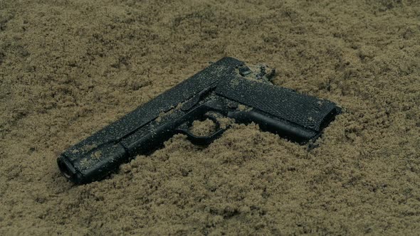 Hand Gun Dropped In The Sand alt