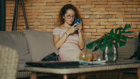 Happy Woman Enjoy Success on Mobile Phone. Joyful Woman Taping on Screen. alt