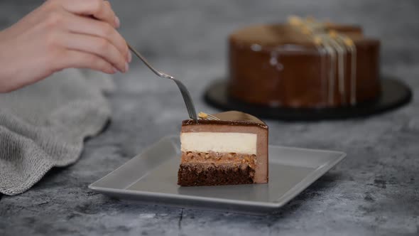 Piece of Chocolate Caramel Peanut Mousse Cake Snickers on a Plate