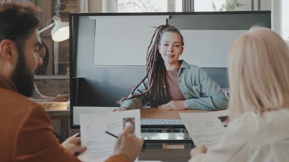 Managers Talking to Job Candidate on Video Call alt