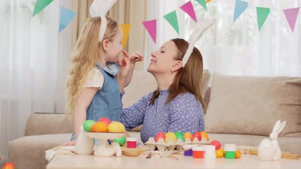 Mom and Little Daughter with Rabbit Ears Celebrate Easter and and Have Fun alt