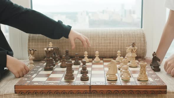 Close Up of Hands Playing Chess alt