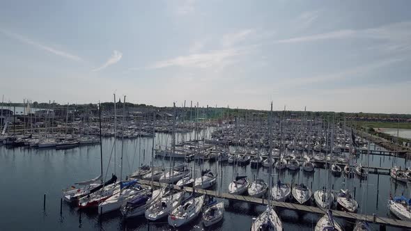 Drone Flies Past Mole And Up Over Sailboat Masts And Ends In Bird's Eye View