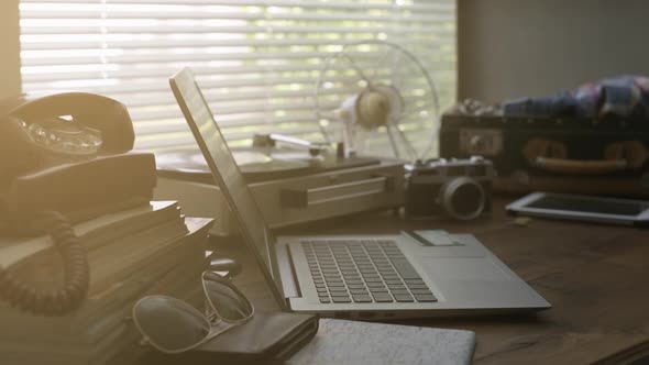 Vintage desk with laptop, record player and fan