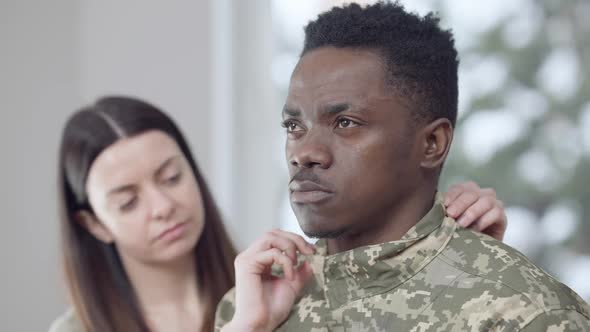 Closeup Portrait of Thoughtful African American Military Man Looking Away As Blurred Caucasian Young alt