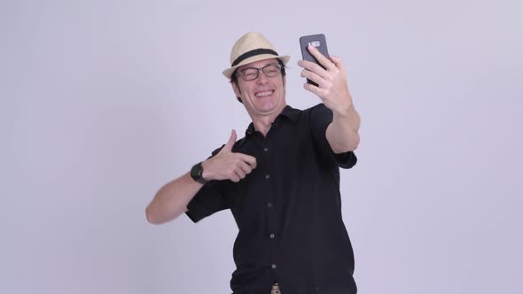 Mature Handsome Tourist Man Taking Selfie and Video Calling alt