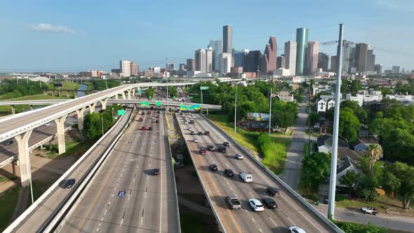 Traffic on interstate. Aerial of Houston Texas skyline as commuters drive on I-45. Rising aerial rev alt